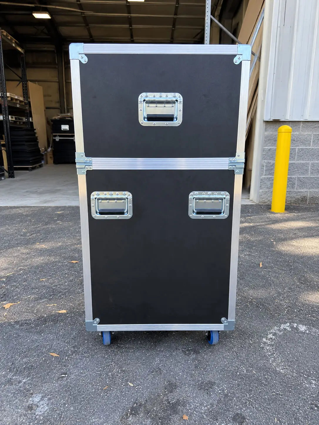 Black 42"-50" TV ATA case with electric lift, closed side view showing aluminum edge protection, handles, and blue wheels