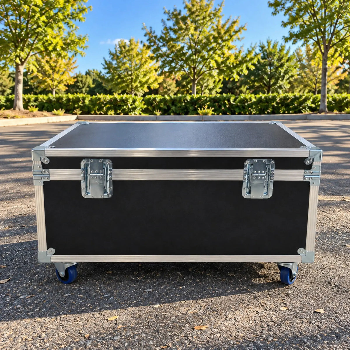 Black jumbo ATA cable trunk, closed back view showing heavy-duty hinges, lid stay straps, and blue casters