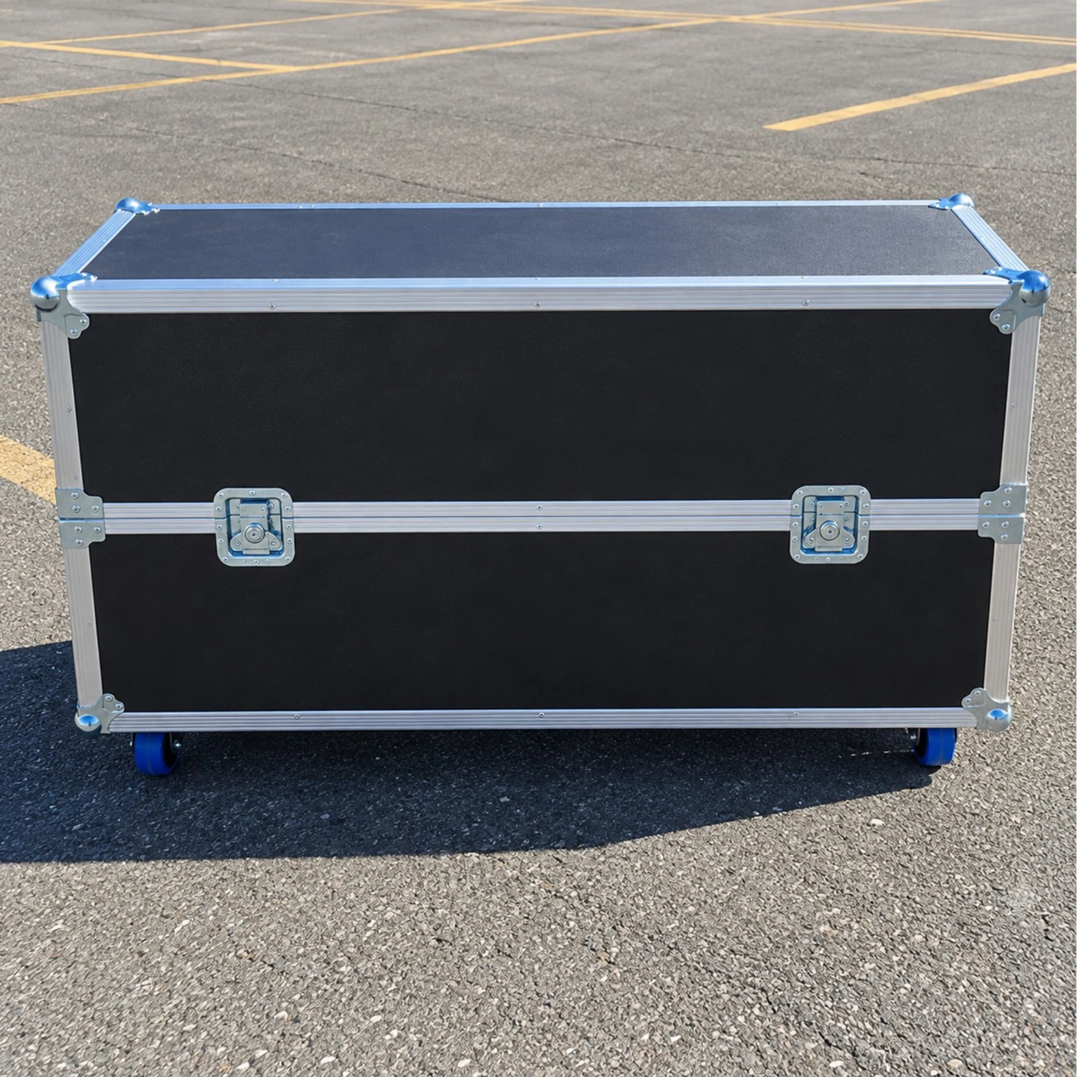 Black multi-screen TV ATA case, closed long side view showing dual recessed twist latches, center seam, and wheels
