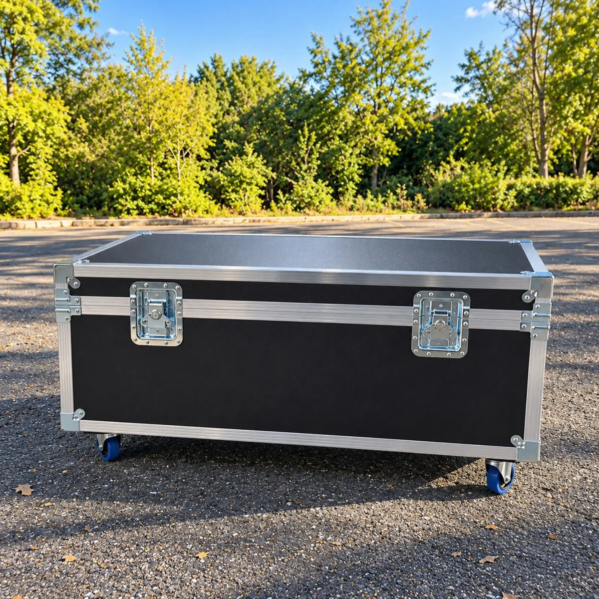 Black jumbo ATA cable trunk, closed front view showing dual recessed twist latches, aluminum trim, and blue wheels
