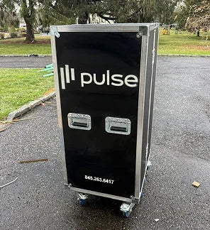 Black equipment case with 'Il-Pulse' branding on a paved surface.